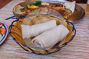 Rolls of Injera in a serving bowl