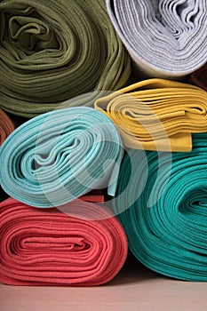 Rolls of knitted fabric in assortment