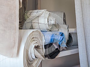 Rolls of linen on the shelf of the fabric store