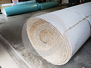 Rolls of new carpet in the garage of house for replace