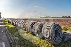 Rolls of new permeable pipes for the construction of a subsurface drainage system