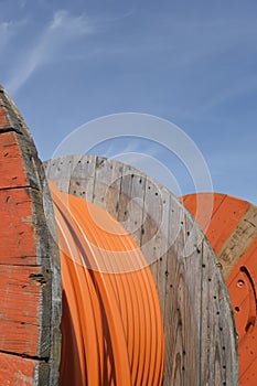 Rolls of orange colored industrial tube cable