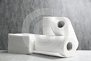 Rolls of paper towels and napkins on marble table