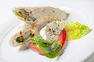 Rolls from pita bread stuffed with meat salad and cheese