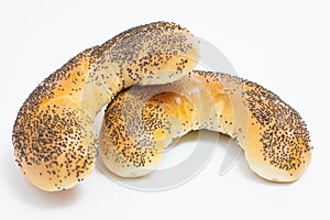 Rolls with poppy seeds on white background