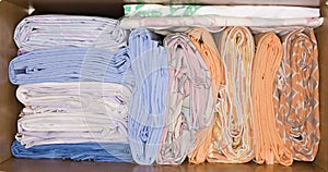 Rolls of sheets on wardrobe closet shelf