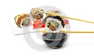 Rolls with smoked eel, avocado and salmon on a white background