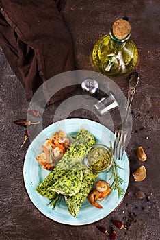 Rolls of spinach pancakes with cheese and shrimps