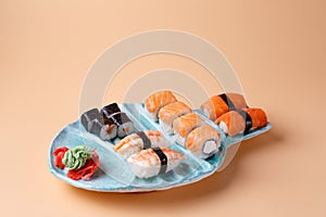 rolls and sushi on a plate in the form of fish