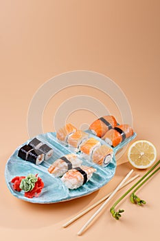 rolls and sushi on a plate in the form of fish