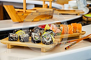 Rolls and sushi in tradtional dishes on the table in asian restaurant