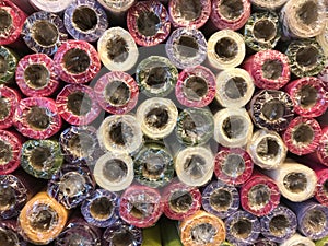 Rolls of textured decorative wrapping paper of different colors on the shelf in the store