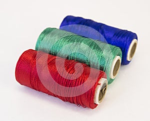 Rolls of thread with RGB colors.