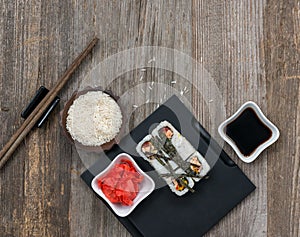 Rolls on tray and a bowl of rice top view