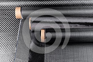 Rolls with various real woven carbon fiber enforcement raw material cloth. composite material industry high tech background