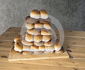 rolls in white and brown from a bakery on a stack with transparent background