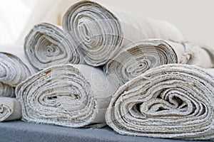 Rolls of white linen fabric handmade
