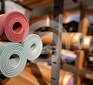 Rolls of yoga mats piled in warehouse storage back room