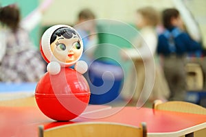 Roly-poly toy stand at table in kindergarten