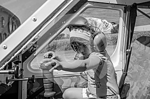 ROMA, ITALY - JULY 2017: Little charming little girl pilot, child in the cockpit of light-engine aircraft Tecnam P92-S Echo