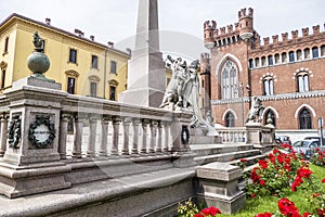 Roma square in Asti with a beautiful palace and an obelisk