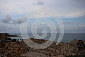 Roman amphitheater of Tarraco in Tarragona on the background of sea and sky, Costa Blanca, Spain photo
