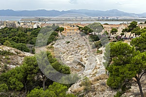 Roman Amphitheatre of Cagliari on a cloudy summer day photo