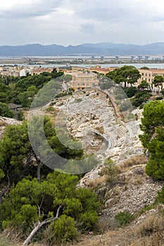 Roman Amphitheatre of Cagliari on a cloudy summer day photo