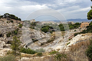 Roman Amphitheatre of Cagliari on a cloudy summer day photo