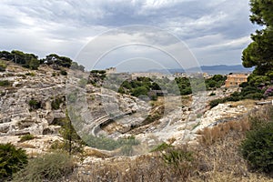 Roman Amphitheatre of Cagliari on a cloudy summer day photo