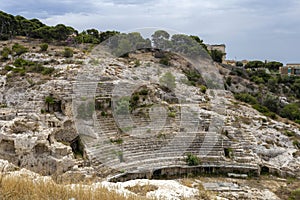 Roman Amphitheatre of Cagliari on a cloudy summer day photo