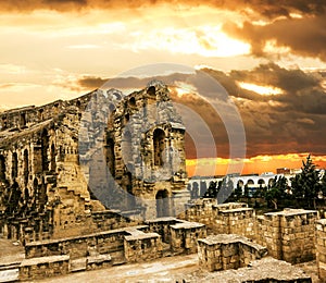 Roman amphitheatre in the city of El JEM in Tunisia amid colorfull sunset