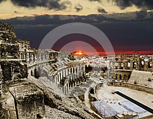 Roman amphitheatre in the city of El JEM in Tunisia amid colorfull sunset