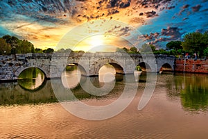 Roman ancient tiberius and augusto bridge over marecchia river in Rimini Italy at sunset or sunsrise