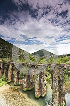 Roman aqueduct of Nikopolis against beautiful cloudy sky in Gree