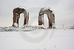 Roman aqueduct ruins and snow