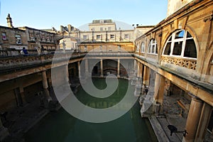 Roman Bath, UK - December 6, 2013: Tourists visiting inside Roman Baths complex. City of Bath is a UNESCO World Heritage Site. Se