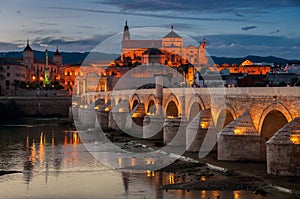 Roman bridge and La Mezquita at sunset in Cordoba