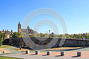 Roman bridge and New Cathedral of Salamanca, Spain photo