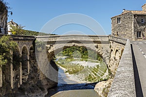 Roman bridge and old town in vaison la romaine photo
