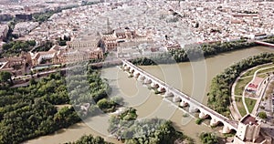 Roman Bridge over the Guadalquivir from aerial panoramic view with Mosque-Cathedral in Cordoba