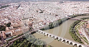 Roman Bridge over the Guadalquivir from aerial panoramic view with Mosque-Cathedral in Cordoba