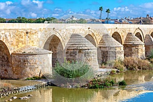 Roman bridge over Guadalquivir river in Cordoba photo
