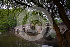 Roman bridge reflection on river Bosna in Sarajevo