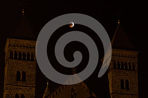 Roman church with above a moon eclipse
