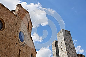 Roman church`s facade and towers in San Gimignano, Tuscany