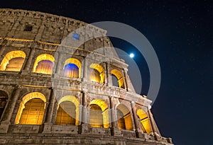 Roman Colosseum at Night under Full Moon and Starlight in Rome, Italy