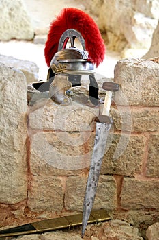 Roman guard helmet with red crest, and short sword or