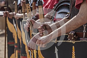 Roman legionaries in formation. Hands holding pila, javelin photo