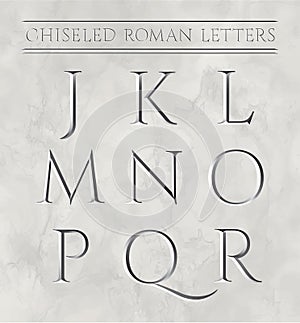 Roman letters chiseled in marble stone.